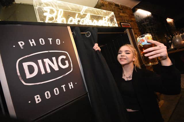 Barmaid Katie Hay shows off the venue's in house photo booth.