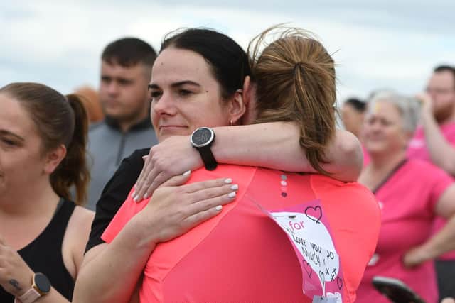 Runner and supporter hug at the Hartlepool Race for Life in July 2022.