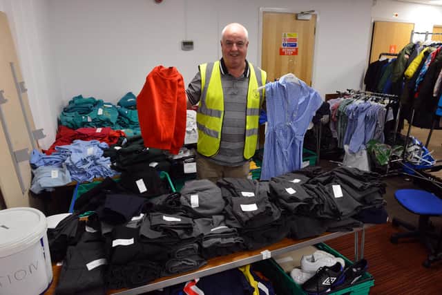 Dave Hunter with some of the free school uniforms available from the shop.