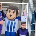 Jack Dale and his dad John meet H'Angus at Hartlepool United Football Club as Jack gets ready to complete his final three miles of his 50-mile triathlon.