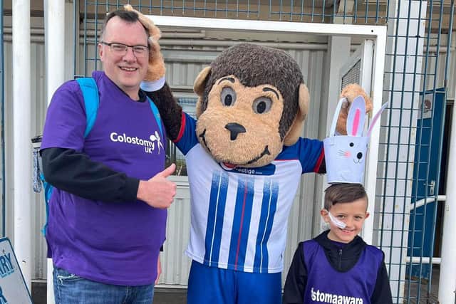 Jack Dale and his dad John meet H'Angus at Hartlepool United Football Club as Jack gets ready to complete his final three miles of his 50-mile triathlon.