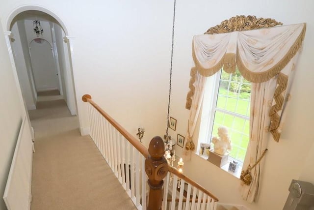 The original staircase with oak rail leads to the first floor of the home.