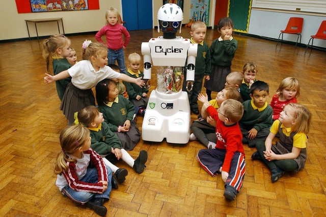 Saying hi to the recycling robot which visited St Joseph' School in Hartlepool in 2004.