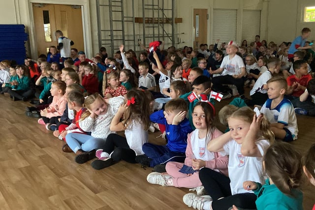 England fans at Clavering Primary School celebrate the forth goal, while some cover their ears from the noise.
