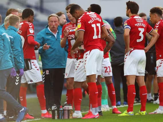 Middlesbrough boss Neil Warnock speaks to his players.