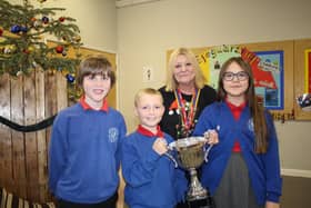 Hartlepool Rotary President Jane Tilly presents the trophy to Throston Primary School pupils Harry Fletcher (left), head noy Lucas Murphy and head girl Lilly Ward.