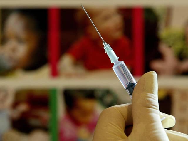 A nurse handles a syringe. Photo PA Images