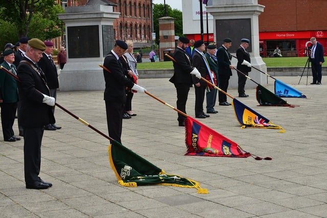 Standard bearers for several forces associations are lowered during the service. Picture by FRANk REID