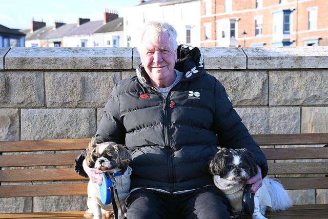 Jimmy Atkinson takes a break with his dogs Peyton and Geordie.