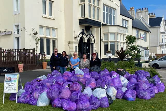 Left to right: Seaton Slimming World consultant Nicci Hardy,  members Sarah, Glynis and Sue and Headland consultant Gill Barkworth with the huge pile of clothes they collected and bagged up.