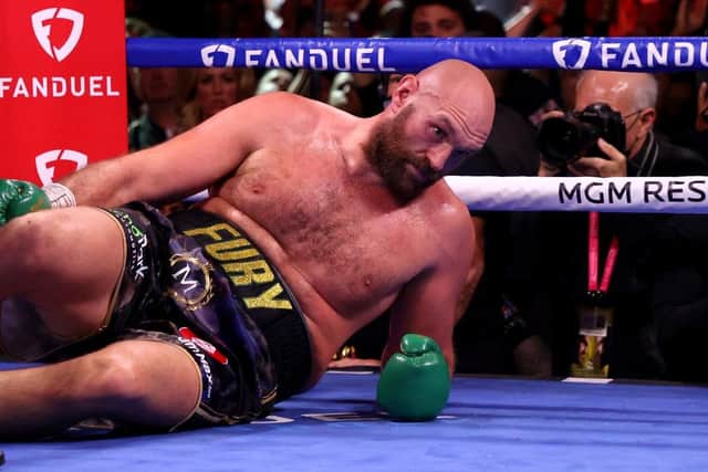 Tyson Fury reacts after being knocked down by Deontay Wilder in the fourth round during their WBC heavyweight title fight at T-Mobile Arena on October 09, 2021 in Las Vegas, Nevada. (Photo by Al Bello/Getty Images)