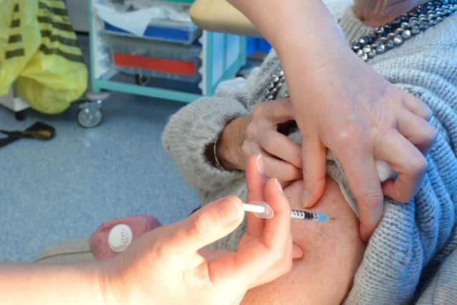 A covid vaccine being administered.