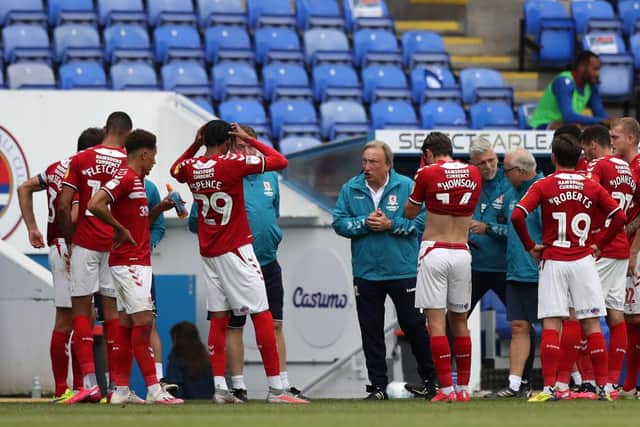Neil Warnock speaks to his players during a 2-1 win at Reading.