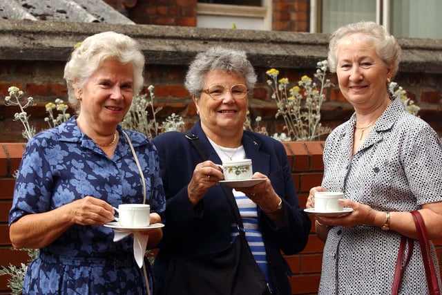These ladies enjoy a lovely afternoon at the Hospice's tea party in 2003.