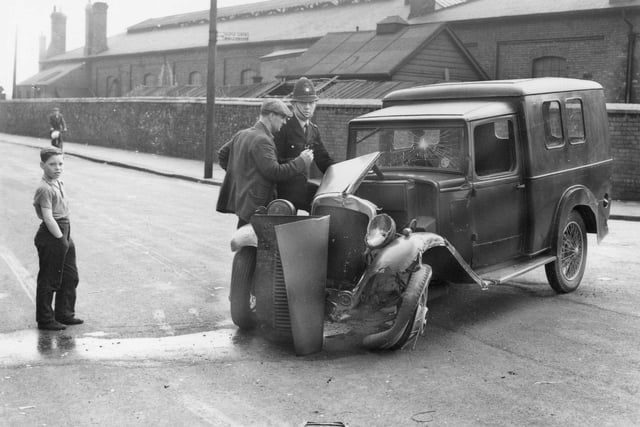 Here, a police officer is pictured dealing with a road traffic accident on Mainsforth terrace where the road heads towards Newburn Bridge. In the background, there is the Hartlepool steam engine depot that has since been demolished.