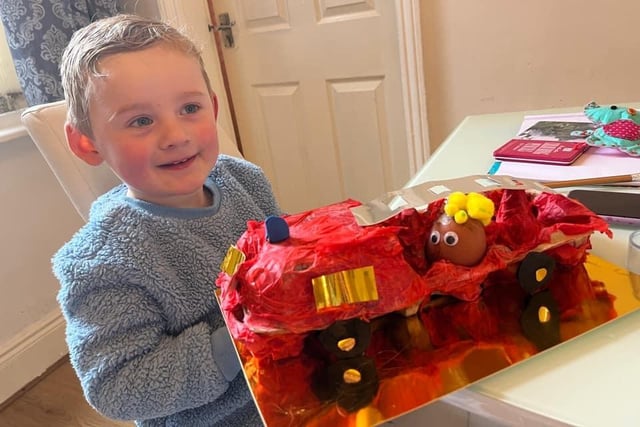Hayden, age 2, shows off his Fireman Sam engine and eggs.