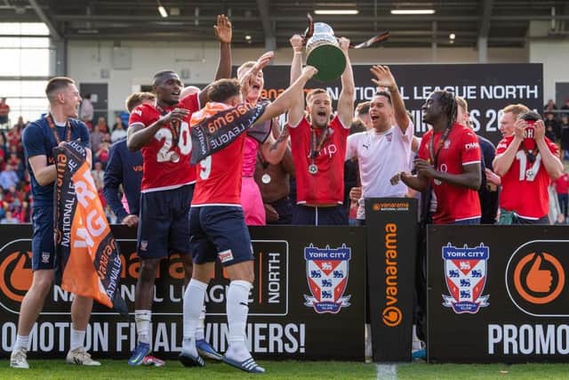 YORK, ENGLAND - MAY 21: York City lift the National League North trophy after winning the National League North Play Off Final match between York City and Boston United at LNER Community Stadium on May 21, 2022 in York, England. (Photo by Emma Simpson/Getty Images)