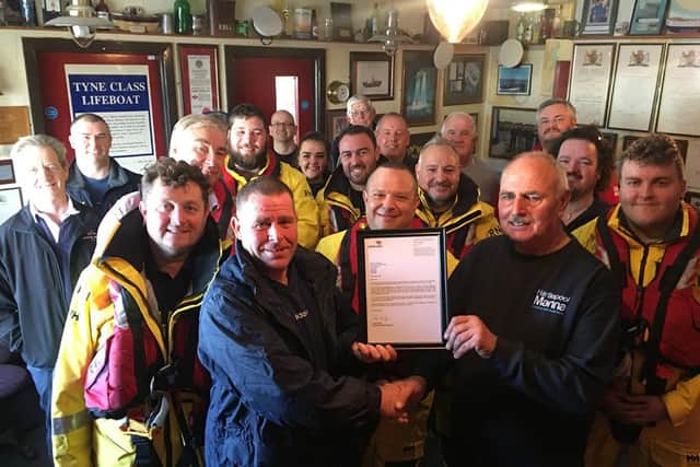 Hartlepool RNLI Lifeboat Operations Manager Chris Hornsey presents Fred Robinson, rightm with a letter of thanks from RNLI operations director John Payne during a presentation at the Ferry Road boathouse.