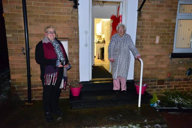 Margery Greener (right) with singer Michelle Newall who surprised her with some doorstep carols. Picture by Frank Reid