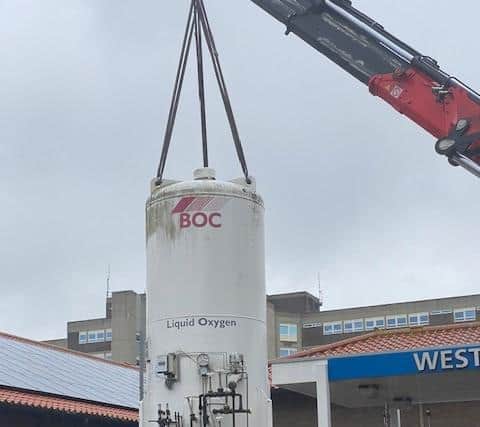 A crane was used to lower the oxygen tank into place.