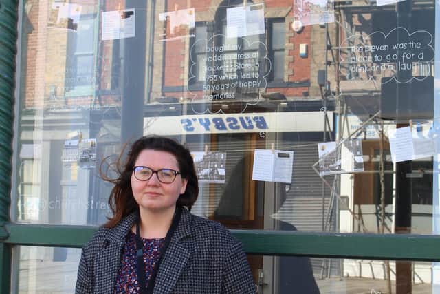 Emma Ackroyd in front of the new Church Street postcards window display.