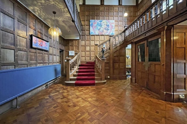 The hallway has exceptional period details, including original wooden panelling.