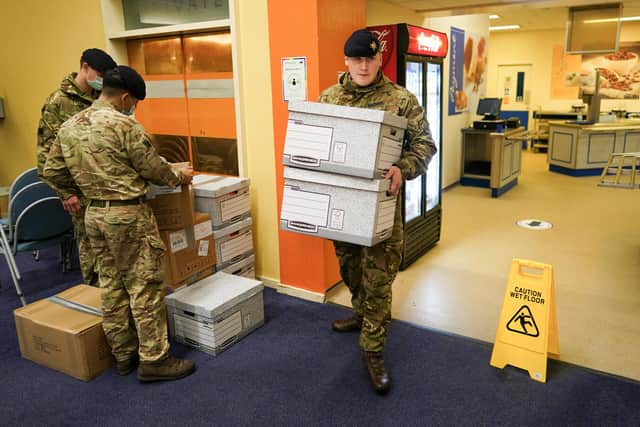 DURHAM, ENGLAND - DECEMBER 05: Soldiers from the Royal Lancers load up welfare packages from the county council for distribution to homes in the county that remain without power on December 05, 2021 in Durham, England. Several thousand people in the North East remain without power more than a week after Storm Arwen battered parts of England and Scotland. As the area faces another bout of wet and windy conditions, members of the British Army's Royal Lancers, a cavalry regiment, are conducting welfare checks on affected residents. (Photo by Ian Forsyth/Getty Images)