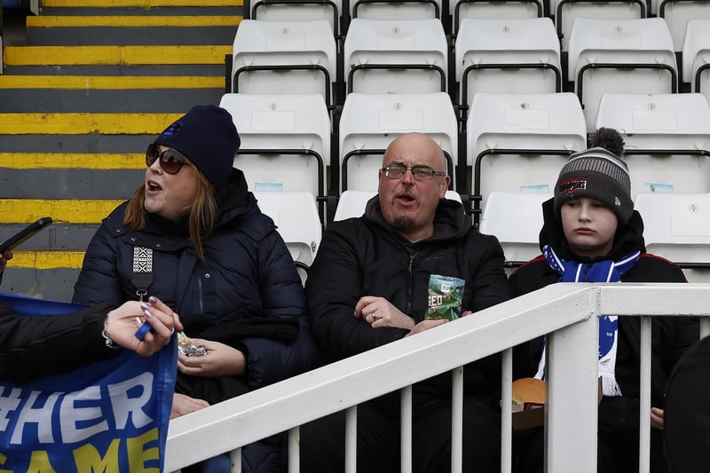 These fans are cheering the players on at their match against Barnet.