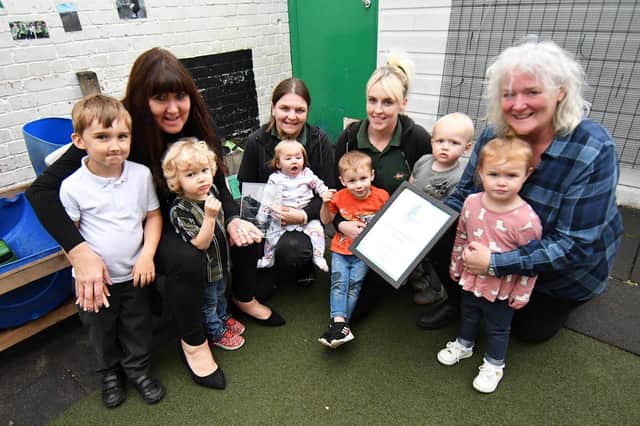 Footprints Nursery owner Sharon Birch, left, holding their award with staff, left to right, Jenny Brown and Jaymie Mathieson and children, left to right, Matthew, Toby, Nancy, Harvey, Charlie and Harriet . Picture and caption by Frank Reid.
