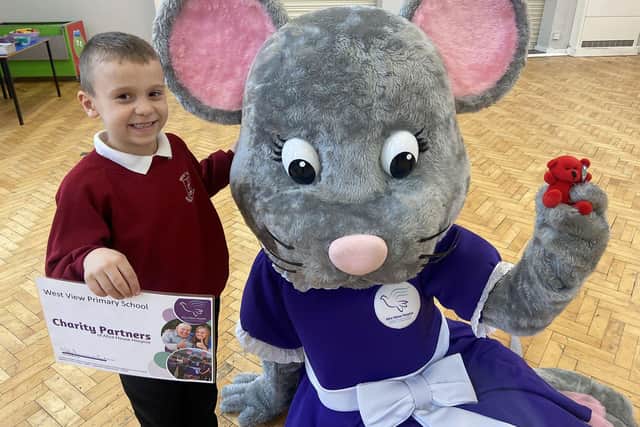 Alice House Hospice mascot Alice Mouse with pupil Ajay Lawson.