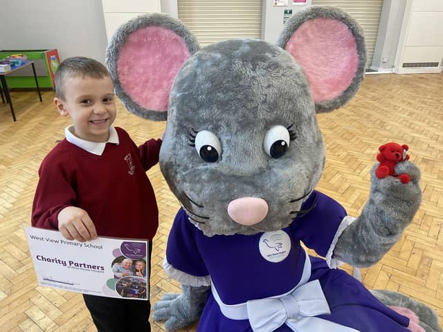 Alice House Hospice mascot Alice Mouse with pupil Ajay Lawson.