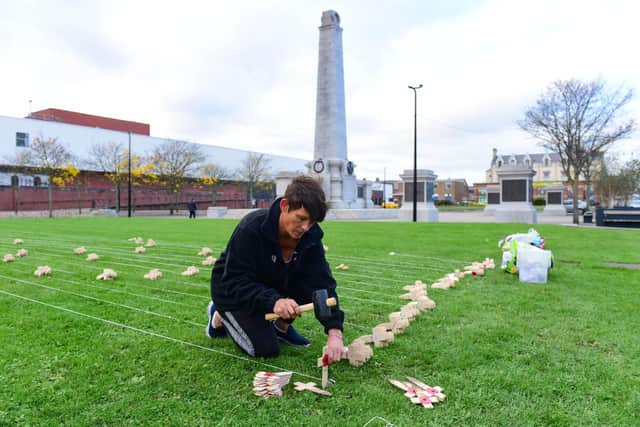 Jaime Horton plating the crosses representing Hartlepool's First World War casualties in Victory Square on Saturday.