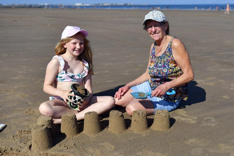 Olive Jobson with her grandmother Betty building sandcastles. Picture by FRANK REID