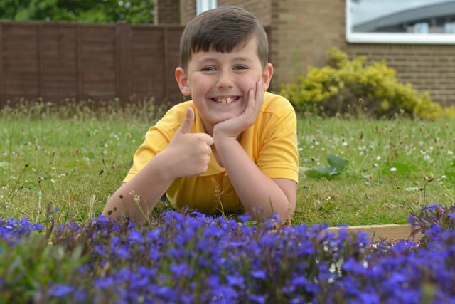 Fens Primary School garden group member, Josh Tucker, at the 50th Year flower bed in 2015.