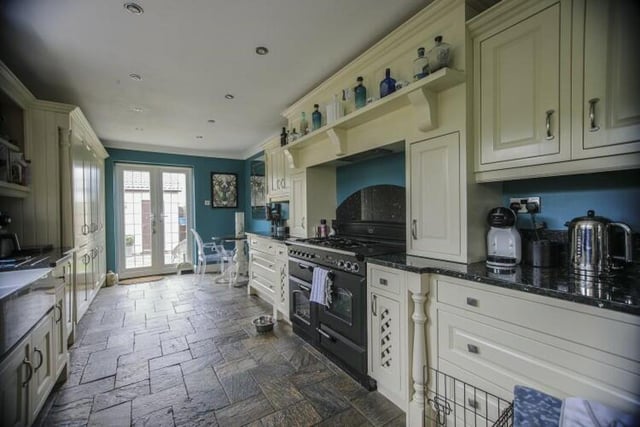 This traditional kitchen has under floor heating and doors that lead to the rear garden.