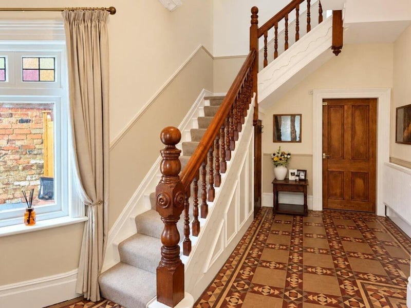 This entrance hall has a spindle staircase leading up onto the first floor and under stairs storage.