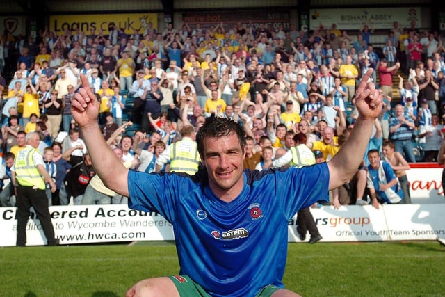 Richie Barker celebrates with the travelling Pools fans at full time at Adams Park.