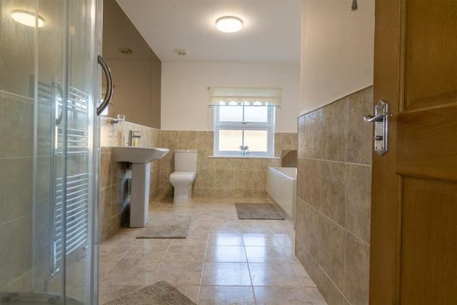 This is a large and modern family bathroom.