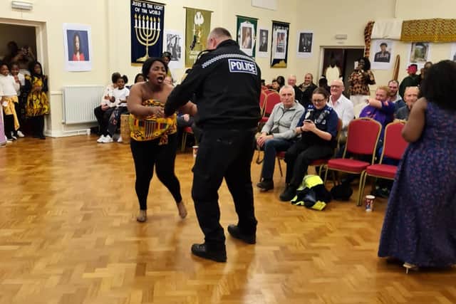 A policeman joins in with some African dancing at Saturday's exhibition.