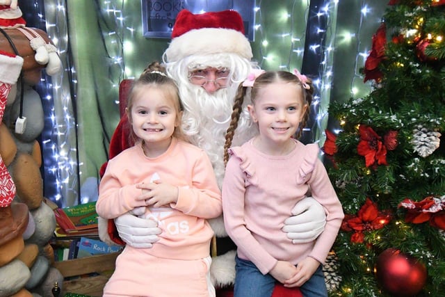 Twins Summer and Lola Thompson (6) with Santa at Middleton Grange Shopping Centre. Picture by FRANK REID