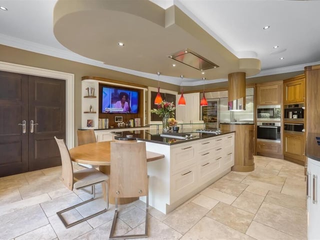 This kitchen is modern in style and has a large island.