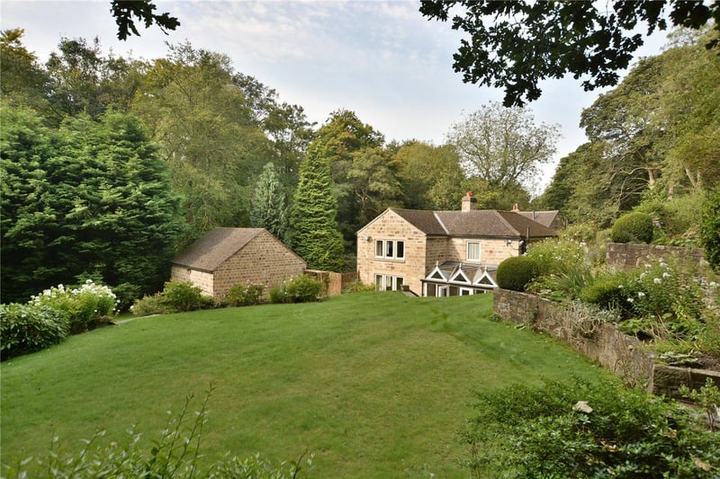 Steps from the terrace give access to a sprawling lawned garden, which leads down to the surrounding woodland.