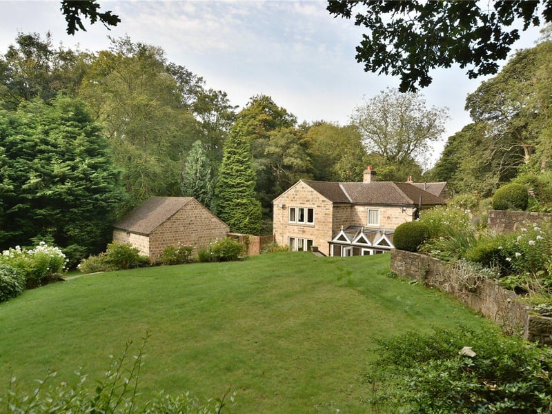 Steps from the terrace give access to a sprawling lawned garden, which leads down to the surrounding woodland.