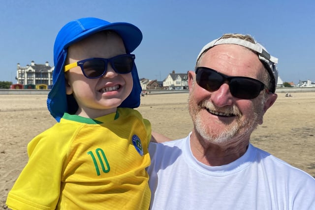Dave Steward, 68, and grandson Harry Crawford, three, keeping cool under their summer hats. Seaton Carew. Picture by FRANK REID