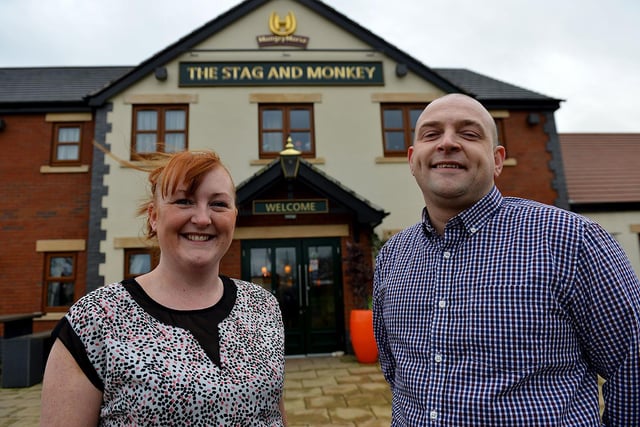 Gary Drake and Rebecca Drake, general managers of the Stag and Monkey, pose for a photo outside the pub.