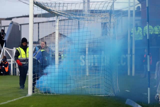 Stewards deal with a flare thrown onto the pitch by Stockport County's fans after their side take the lead against Hartlepool United. (Credit: Mark Fletcher | MI News)