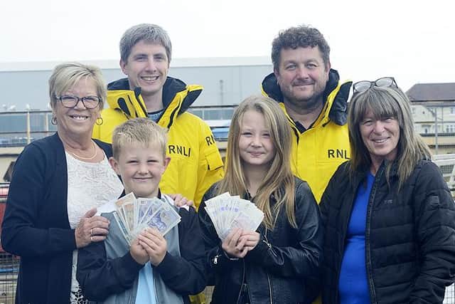 Back row, Hartlepool RNLI volunteers Colm Simpson, left, and Eddie Mason with, front row, Carol Butterfield, left, and Julie Hope, right, and Ellison Readshaw and Poppy Smith, who presented the cash to the charity