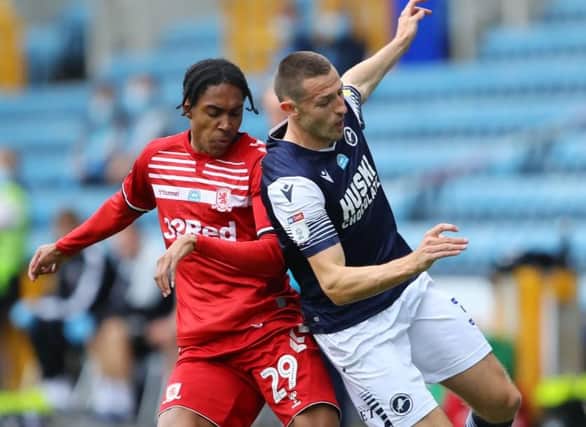 Middlesbrough's Djed Spence challenges for possession against Millwall's Murray Wallace.