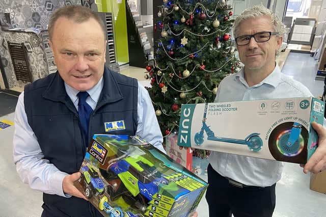 Mick Sumpter (left) and Lee Dees from MKM Building Supplies with some of the presents donated to the Christmas gift appeal. Picture by FRANK REID