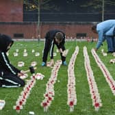 Paddy Brown with young helpers, nine-year-old twins Liam and Shaun Horton, planting the field of crosses in Victory Square, Hartlepool, on Saturday.